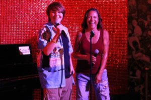 Two people singing karaoke