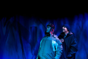 a group of people in a dark room with blue lights